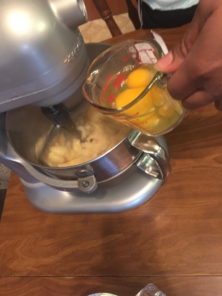 adding eggs to eclair dough