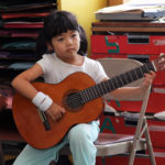 Little girl playing guitar